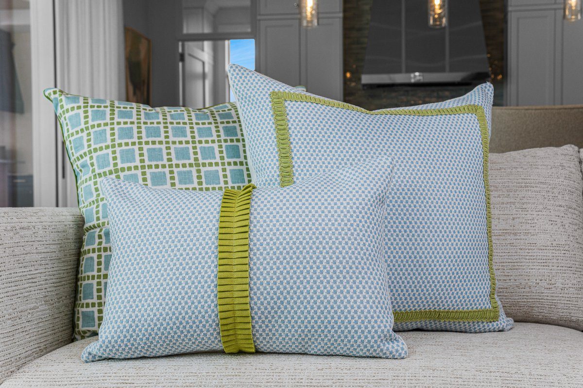 Amy pillow grouping with coordinating blue and green pillows on sofa