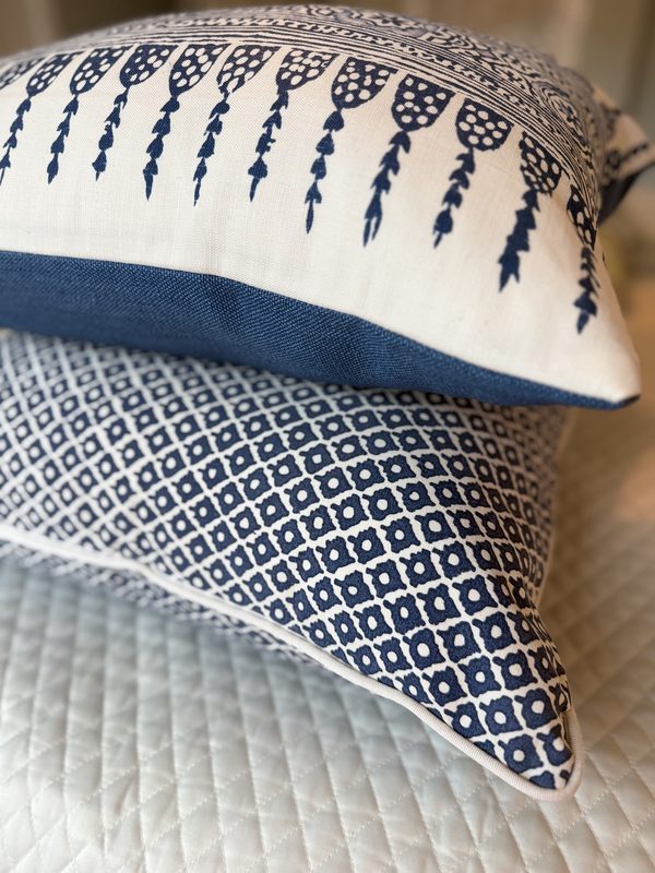 Arbre pillow stacked with navy lumbar showing white piping