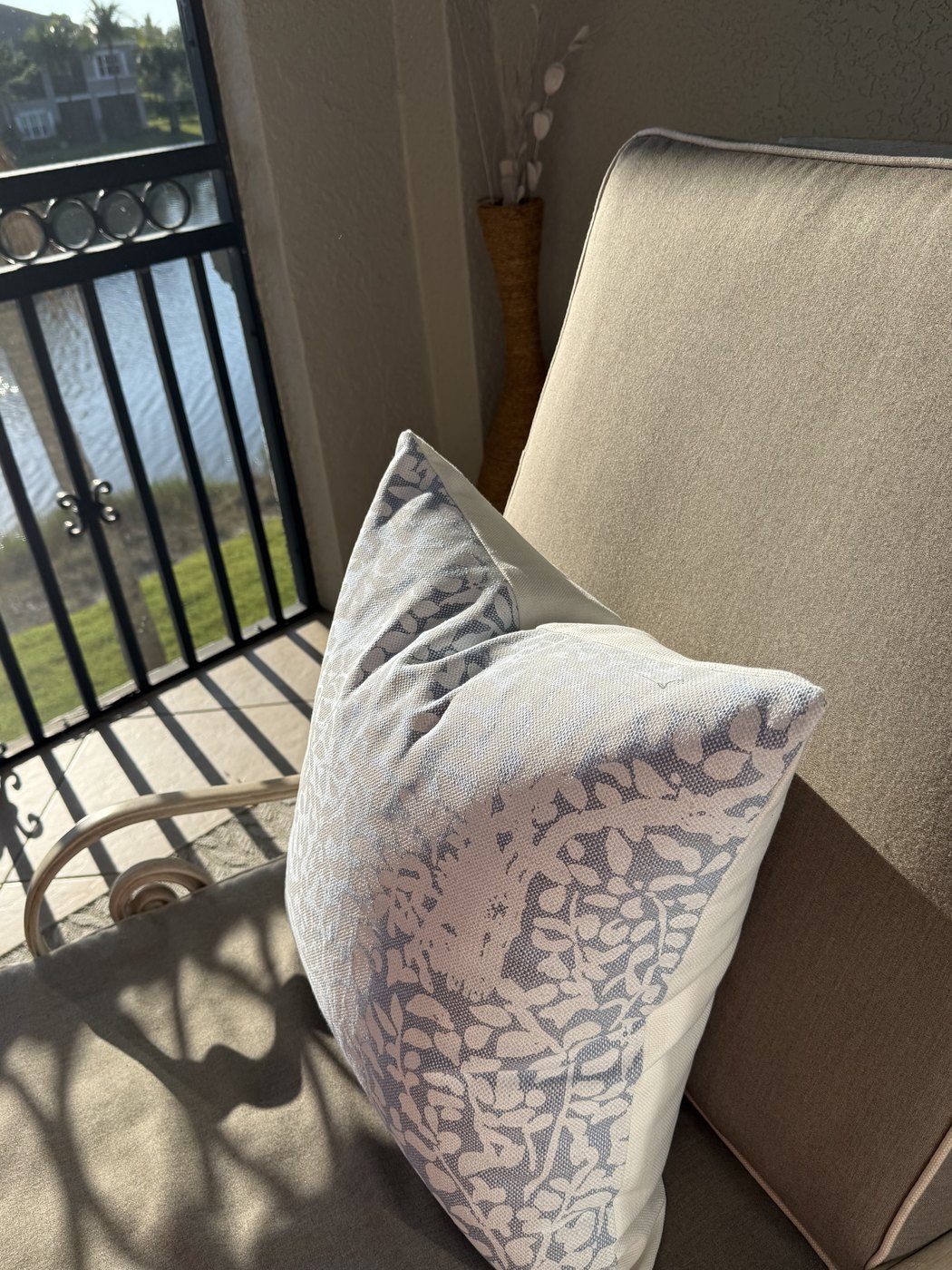 Arbre de Matisse blue and white pillow on outdoor balcony chair