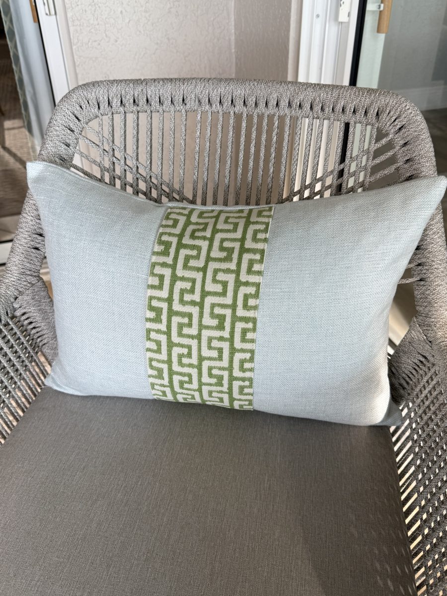 Athena soft blue lumbar pillow styled on woven chair