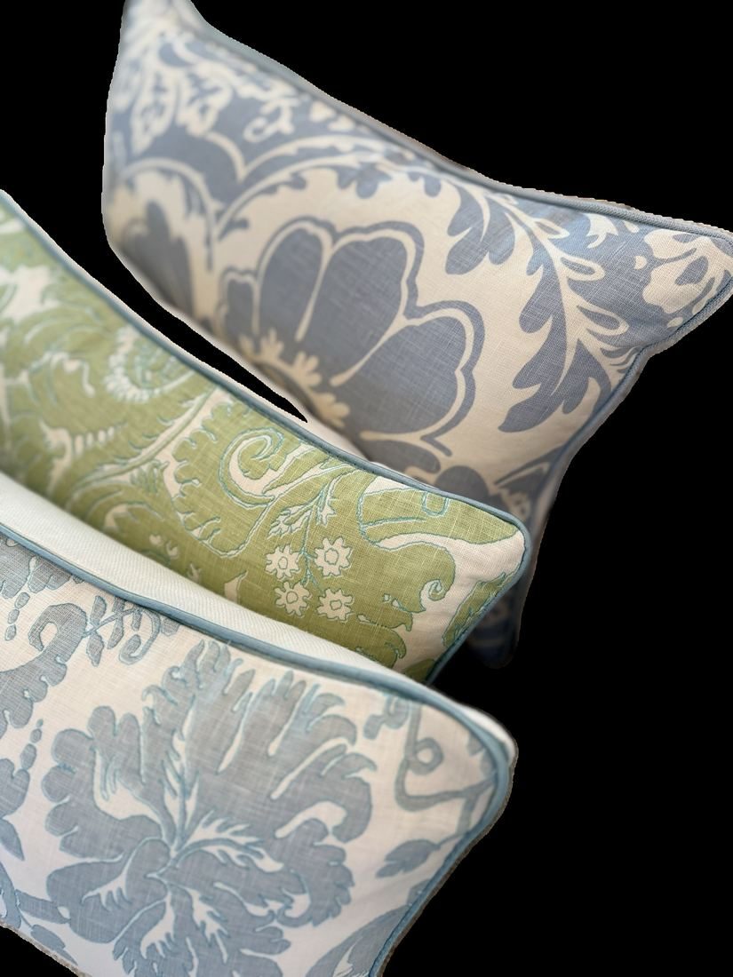 Borghese green lumbar pillow styled on bed