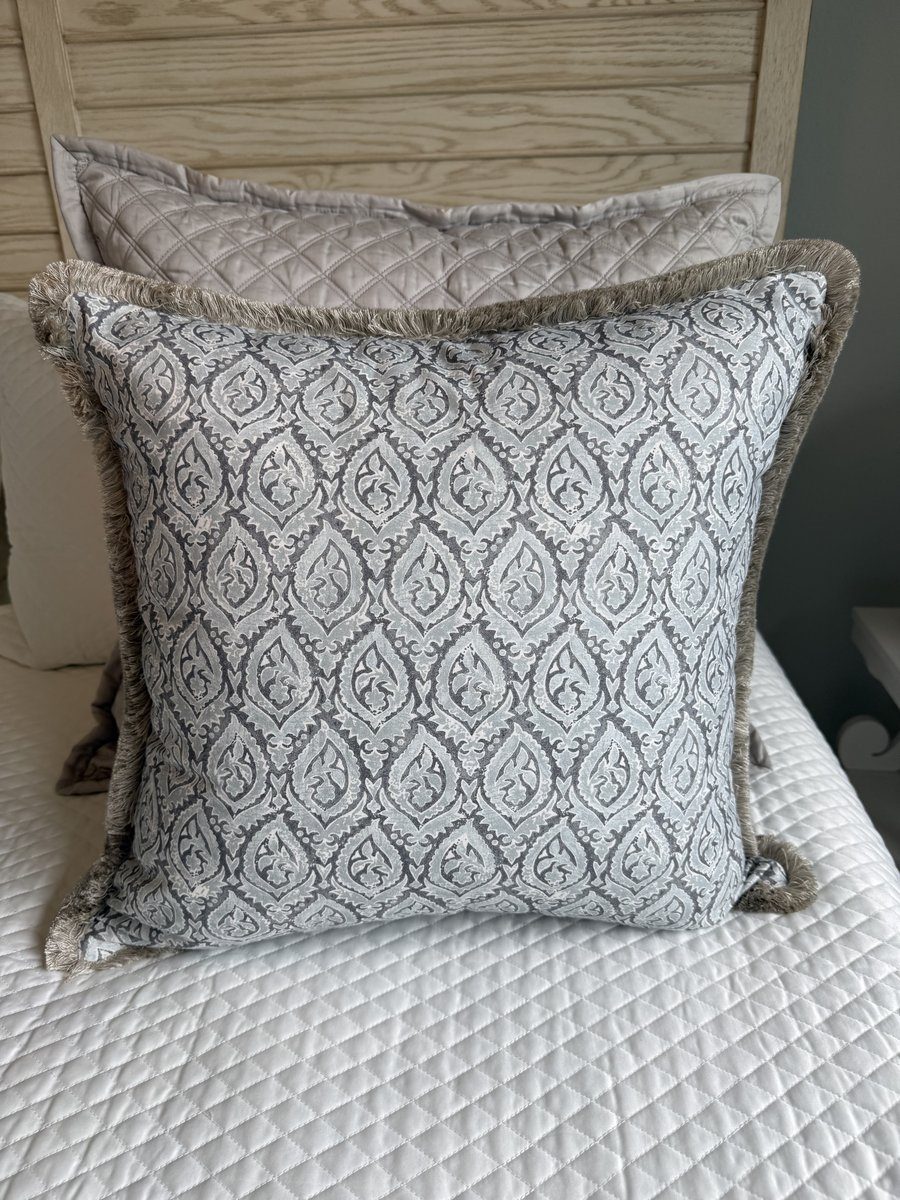 Broadway blue grey block print pillow with oyster fringe styled on bed