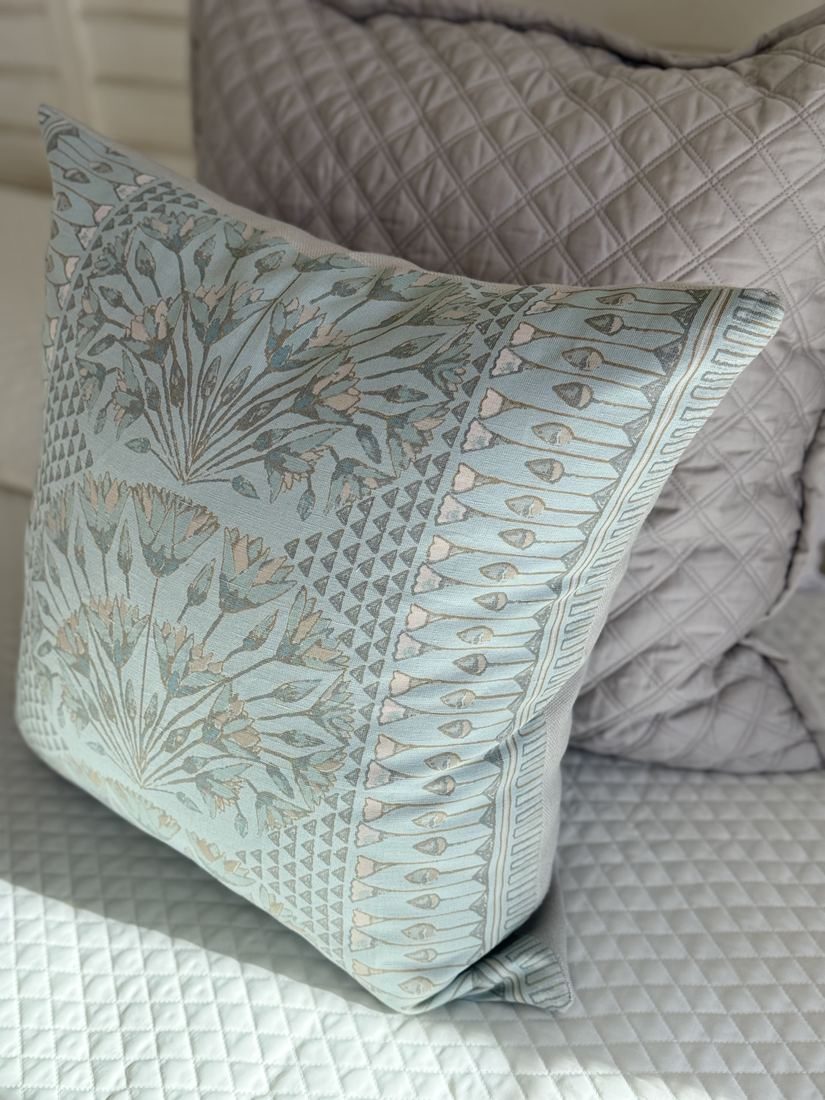 Cairo spa blue lotus print pillow styled on bed