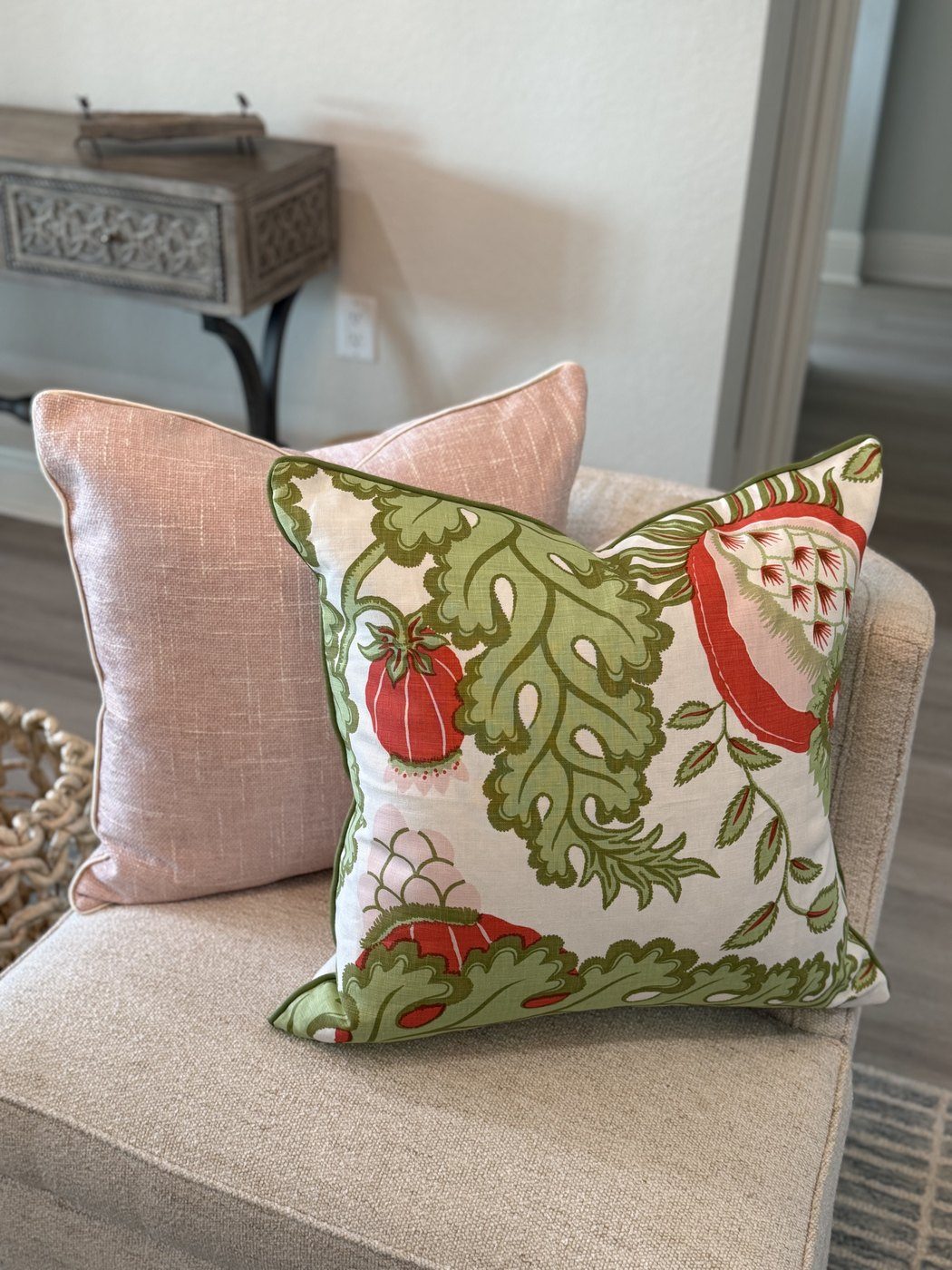 Carnival botanical pillow with blush pillow on chair