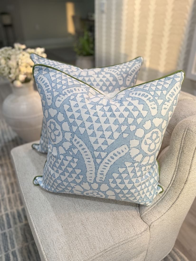 Pair of Chamomile Thibaut pillows on chair