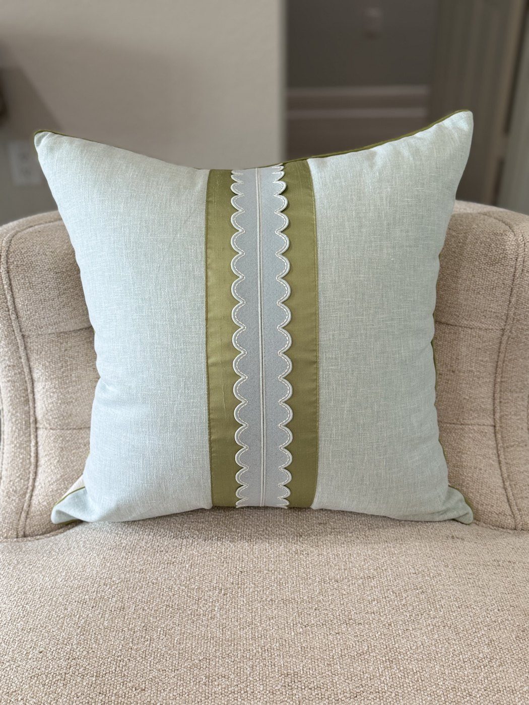 Coastal Scallop sky blue pillow with sage band and scallop trim on armchair by PepperTree Designs