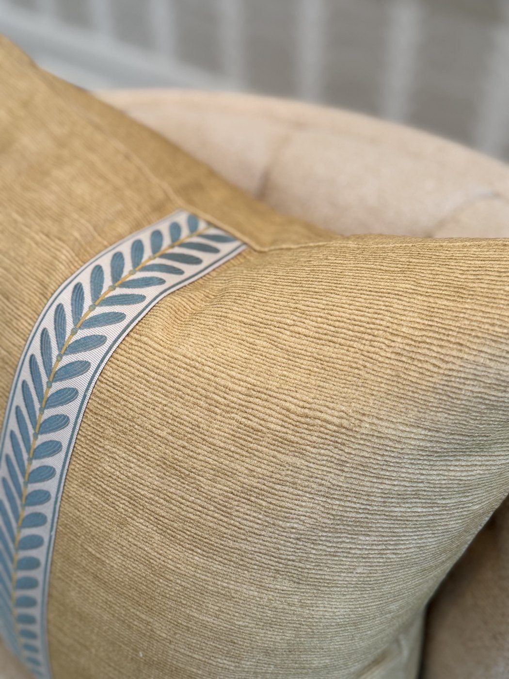 Cornflower Stripe pillow blue and green vine trim close-up on gold