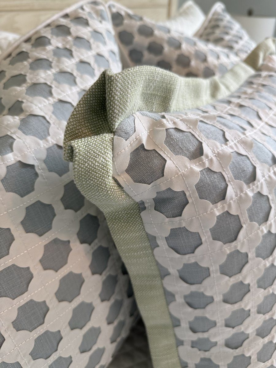 Cothay lattice pillow corner close-up showing sage green flange trim