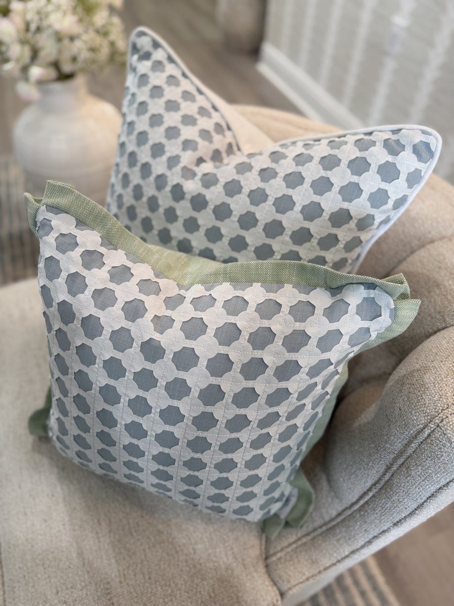 Pair of Cothay soft blue lattice pillows styled on armchair