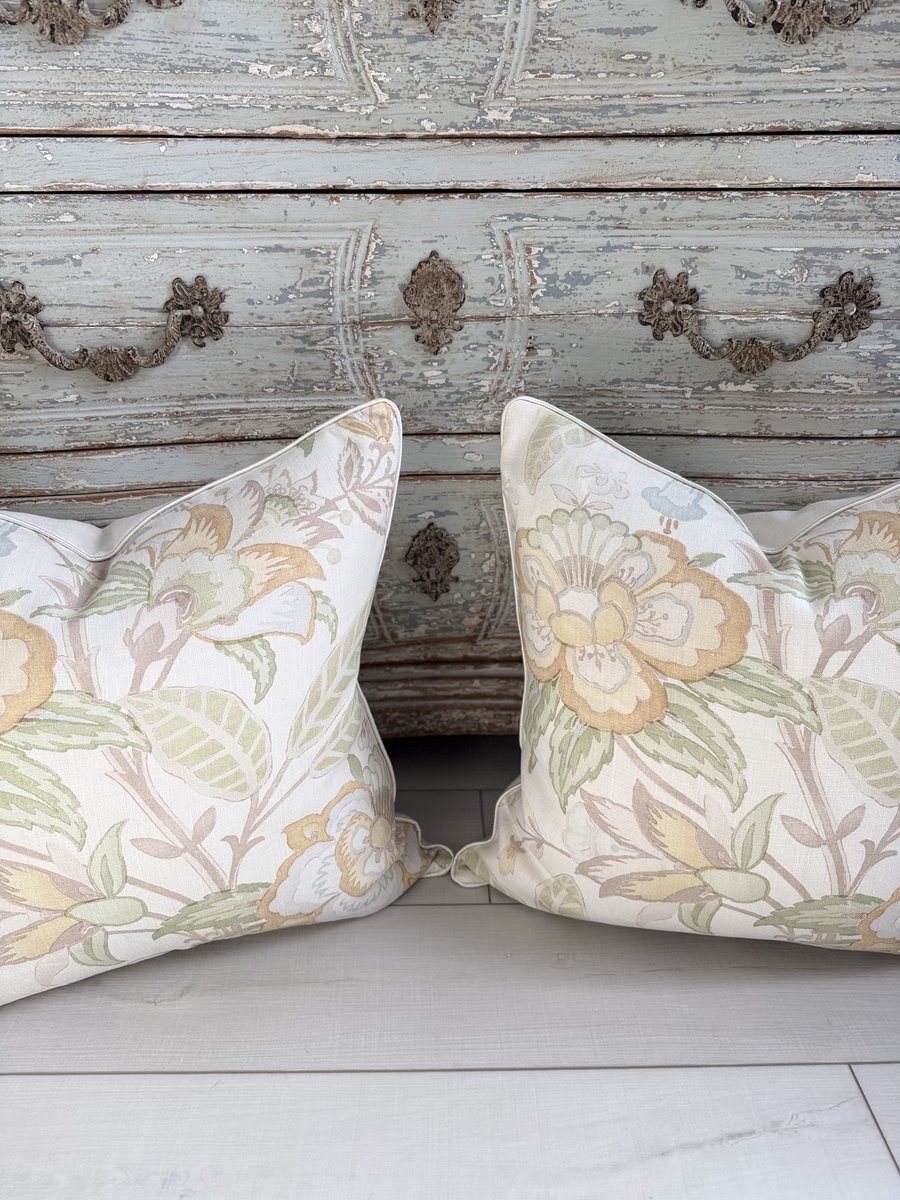 Pair of Davenport floral linen pillows against distressed console