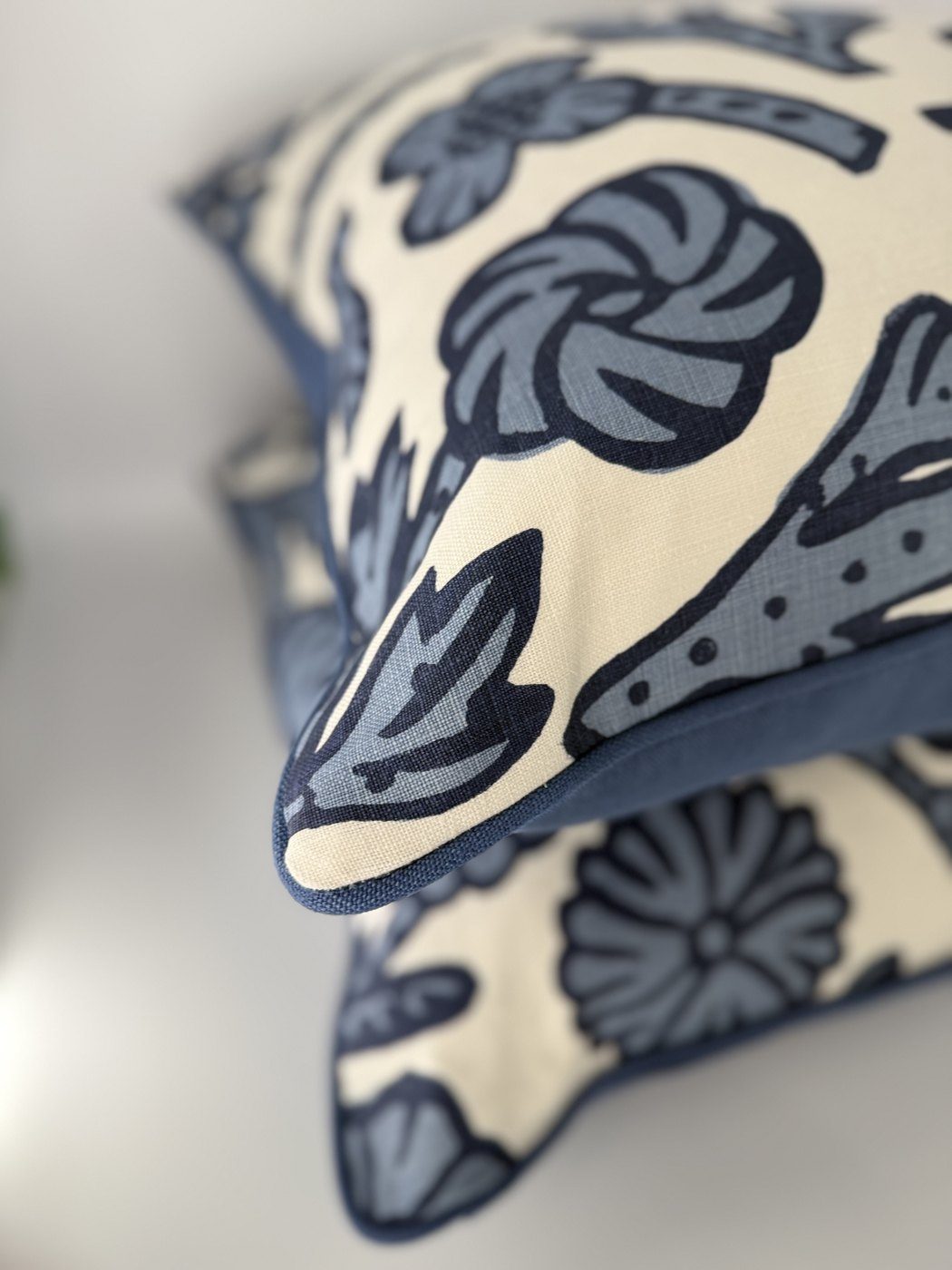Day Floral pillows stacked showing blue piping detail