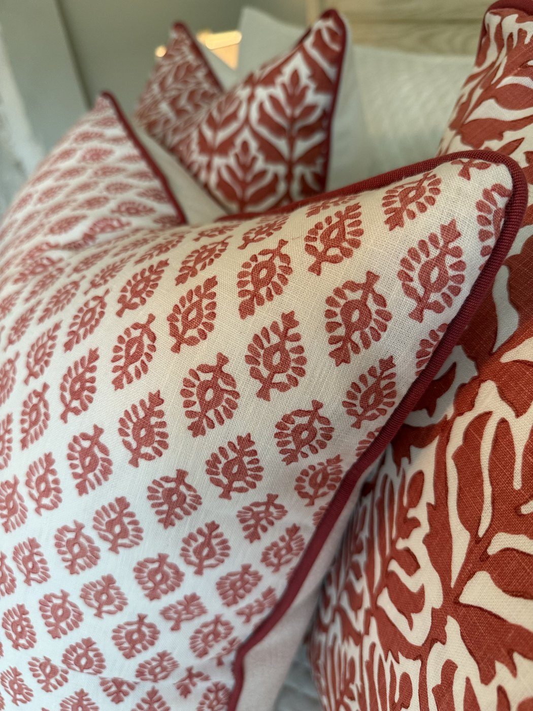 Devi pillow red piping detail with coral pillow grouping