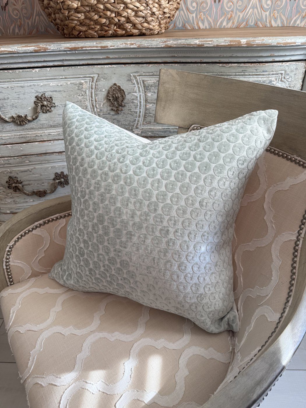 Dotted velvet pillow on French chair with painted chest