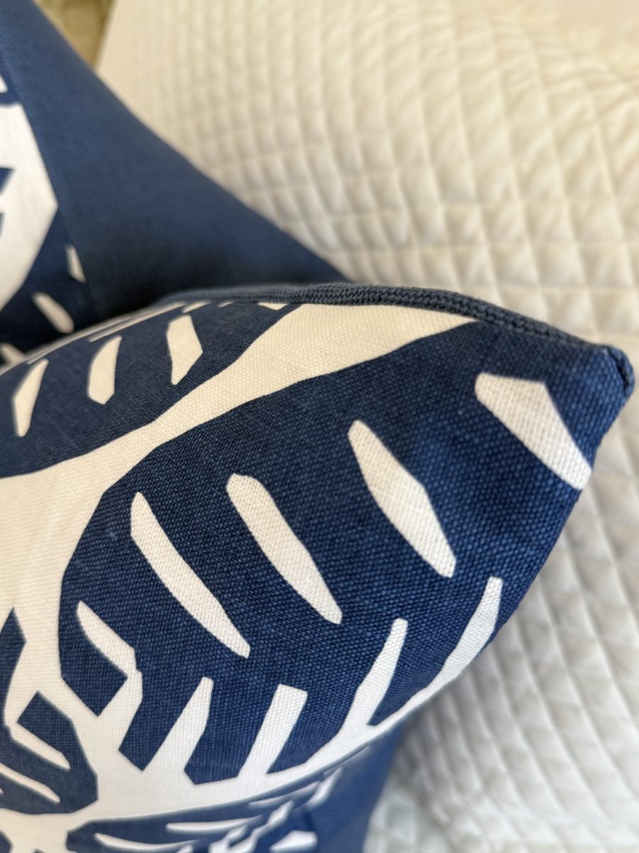 Ginger pillow navy welt trim and palm print corner close-up