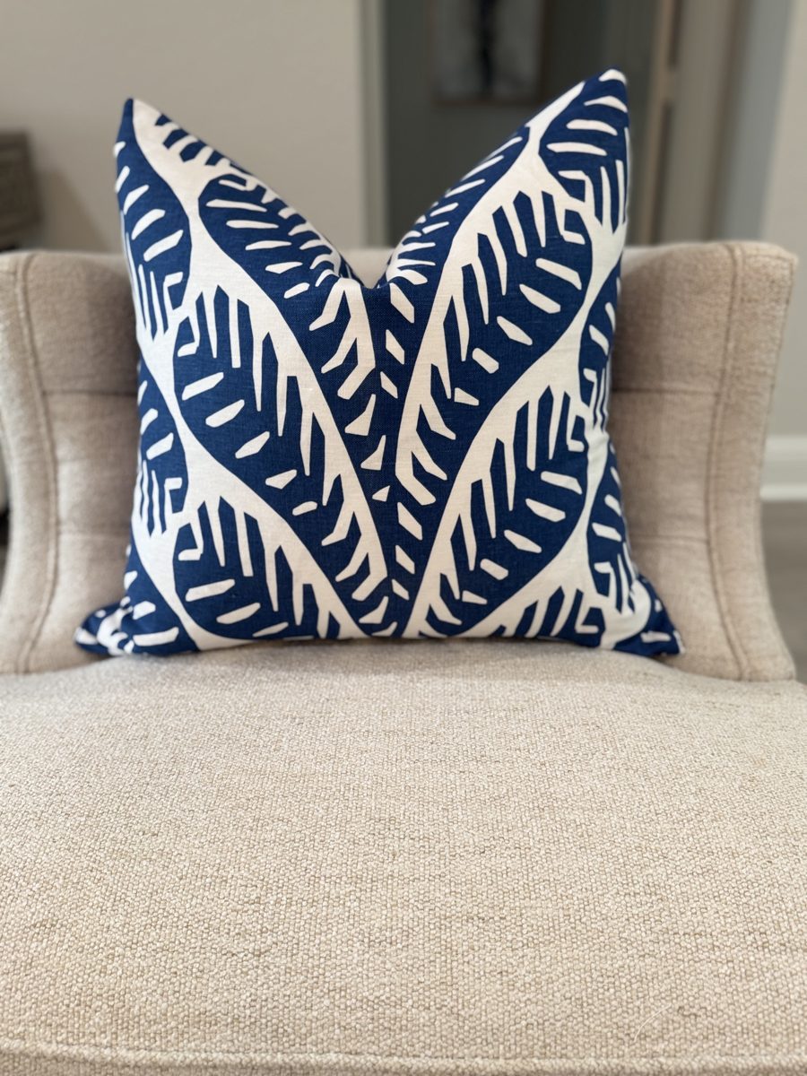 Ginger navy palm print pillow styled on armchair