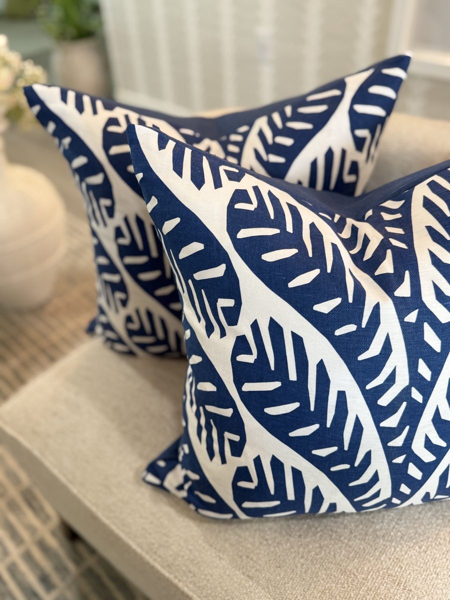 Ginger navy and white palm pillows styled on bench