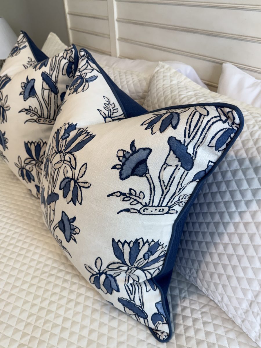 Heidi blue and white floral pillows styled together on bed by PepperTree Designs