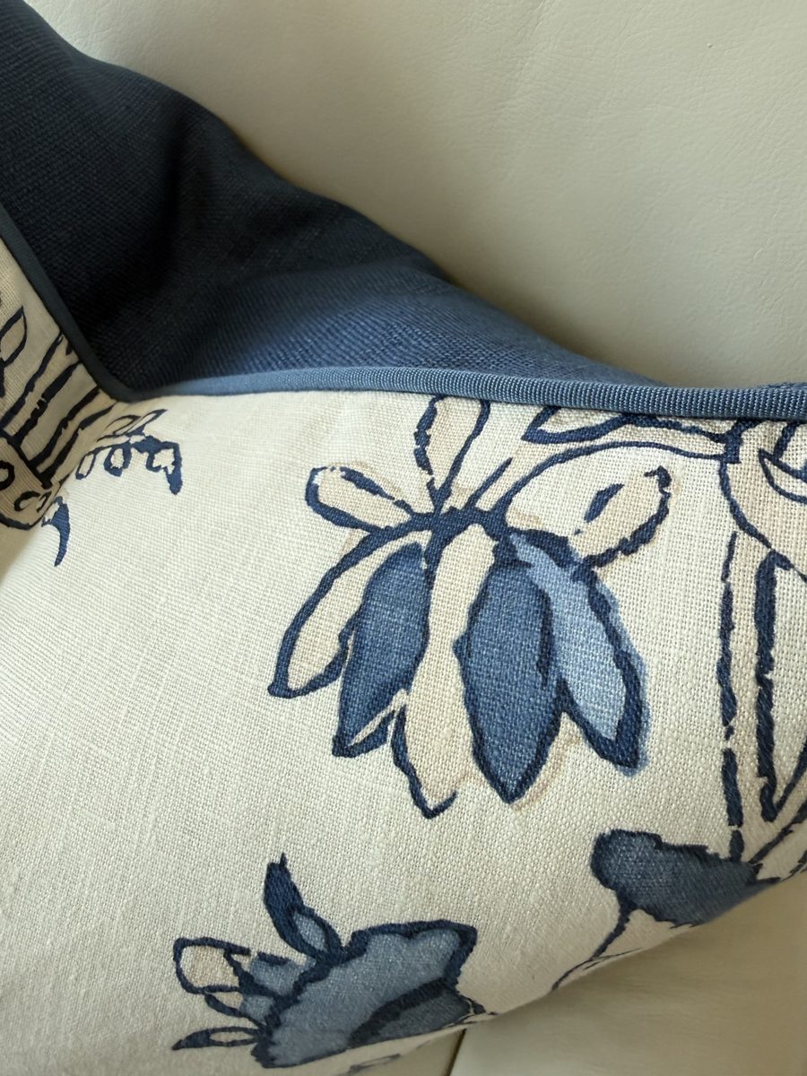 Heidi pillow corner detail with blue piping and navy back