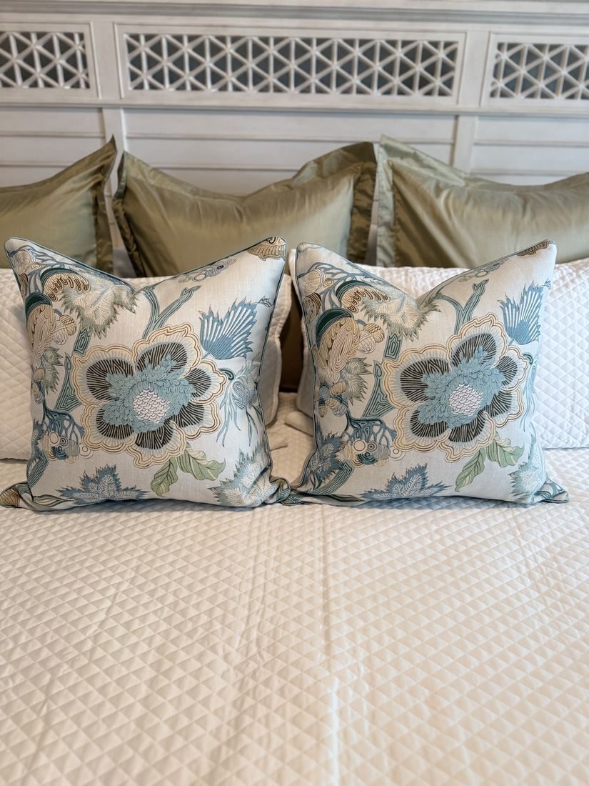 Pair of Indienne Jacobean Thibaut floral pillows on bed