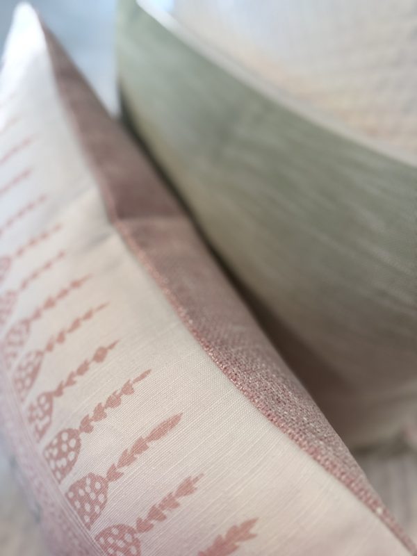 Javanese Stripe pillow edge detail showing blush and soft green backings