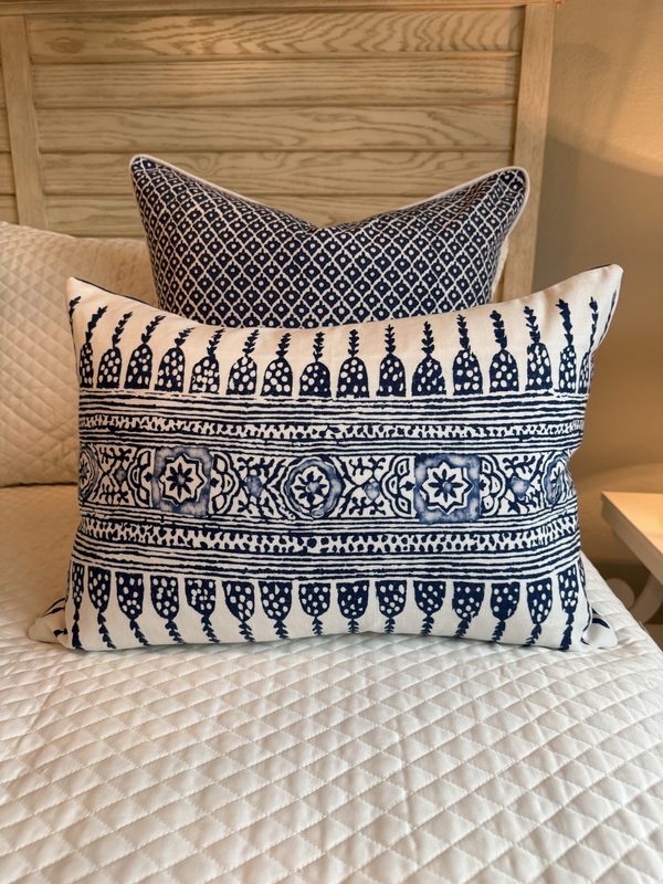 Javanese Stripe navy lumbar on quilted bed