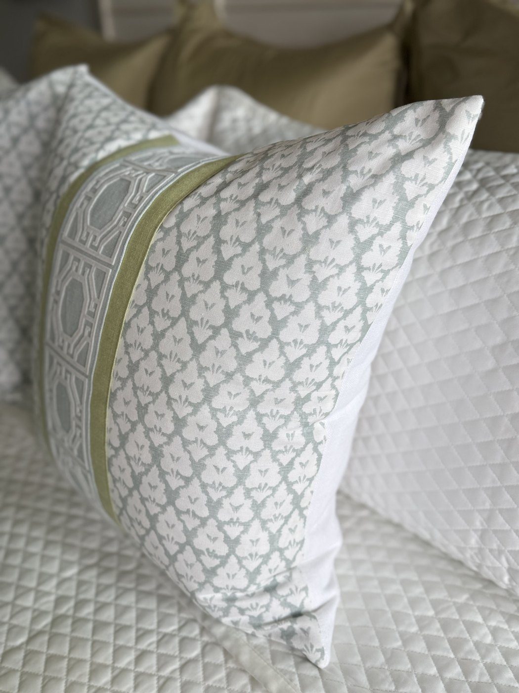 Arboreta Spa Blue pillow with green and blue trim styled on bed by PepperTree Designs