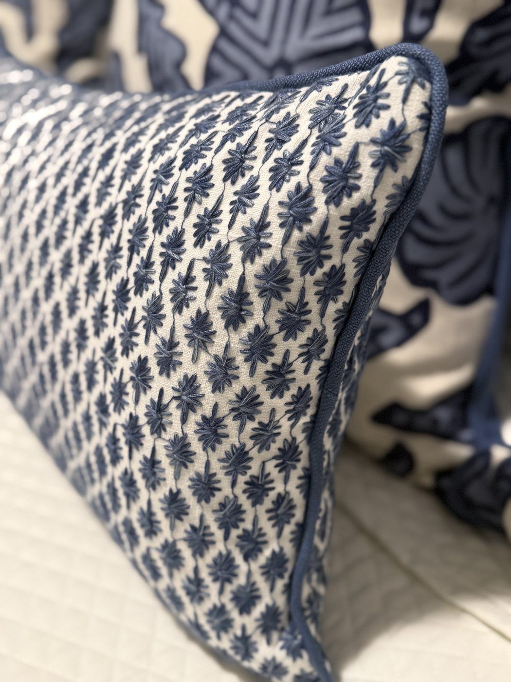 Kristin navy embroidered pillow close-up with navy piping