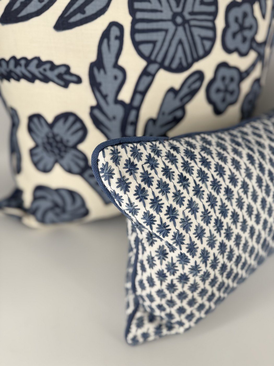 Kristin navy embroidery detail with blue floral pillow