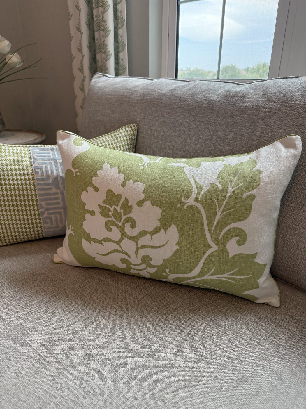 Margate green and white damask lumbar pillow on sofa by PepperTree Designs