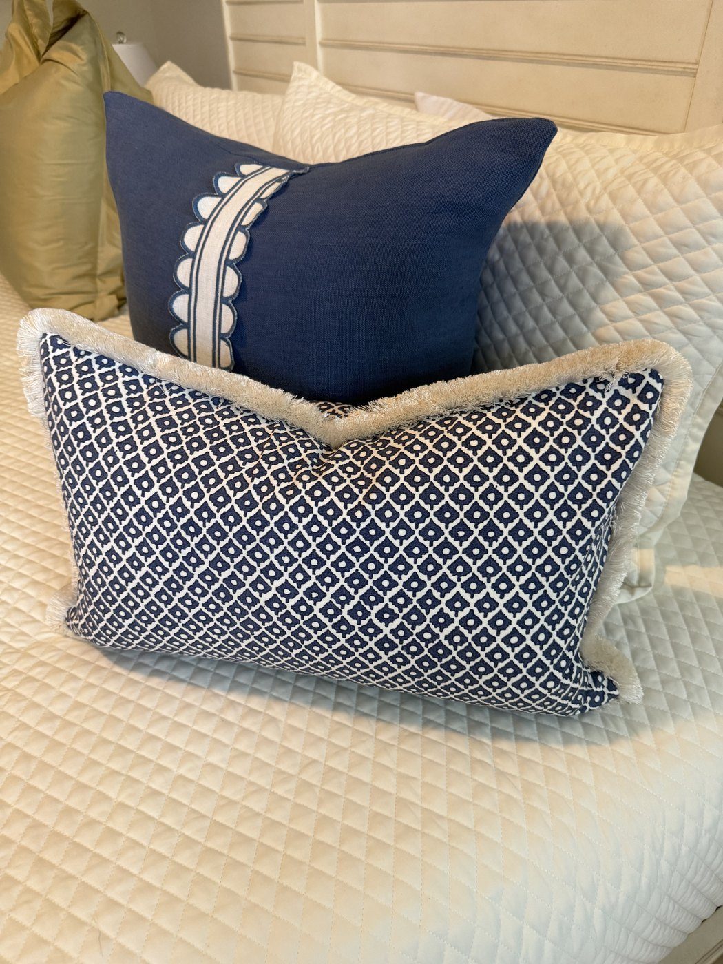 Navy Scallop pillow with Dotti lumbar styled on bed
