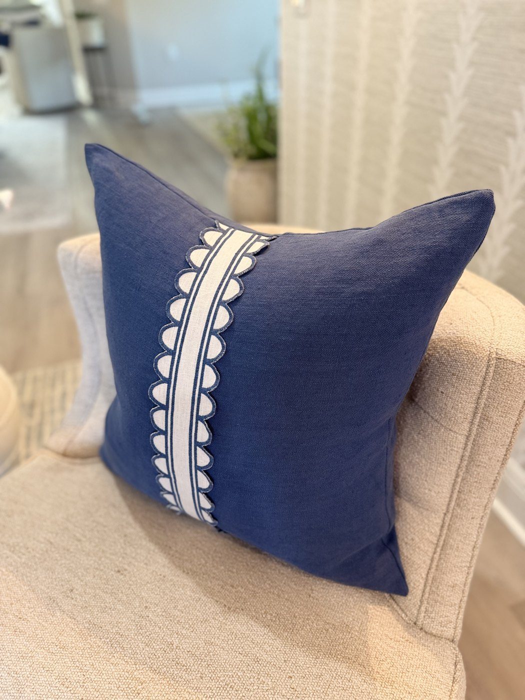 Navy Scallop pillow with scallop tape trim styled on armchair