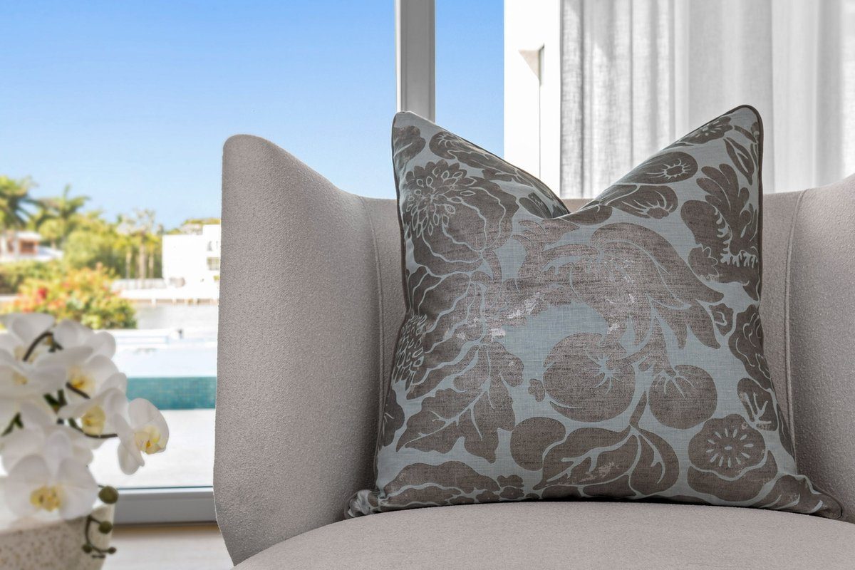 Norden pillow styled on chair with waterfront view