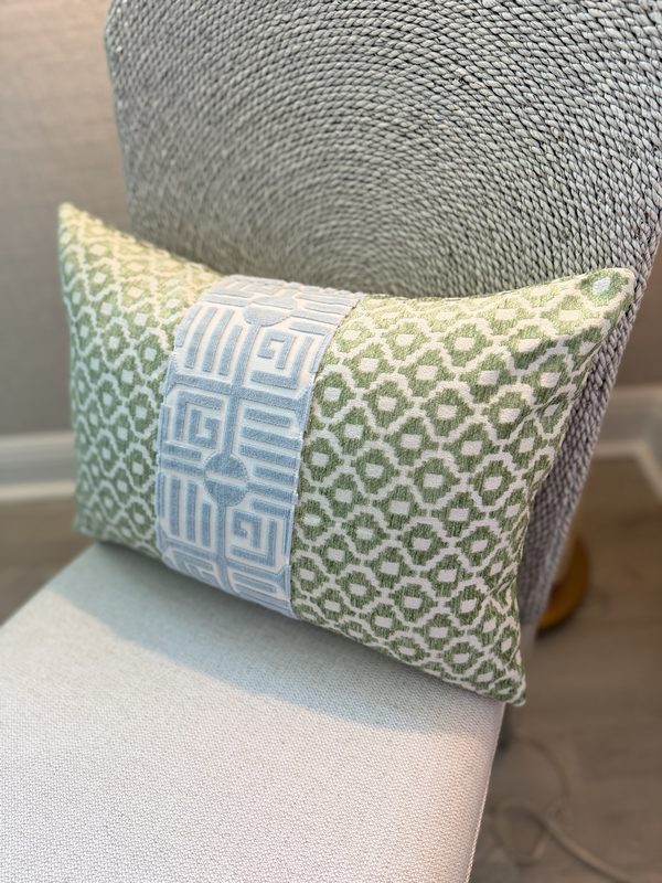 Green lumbar with Labyrinth stripe styled on chair