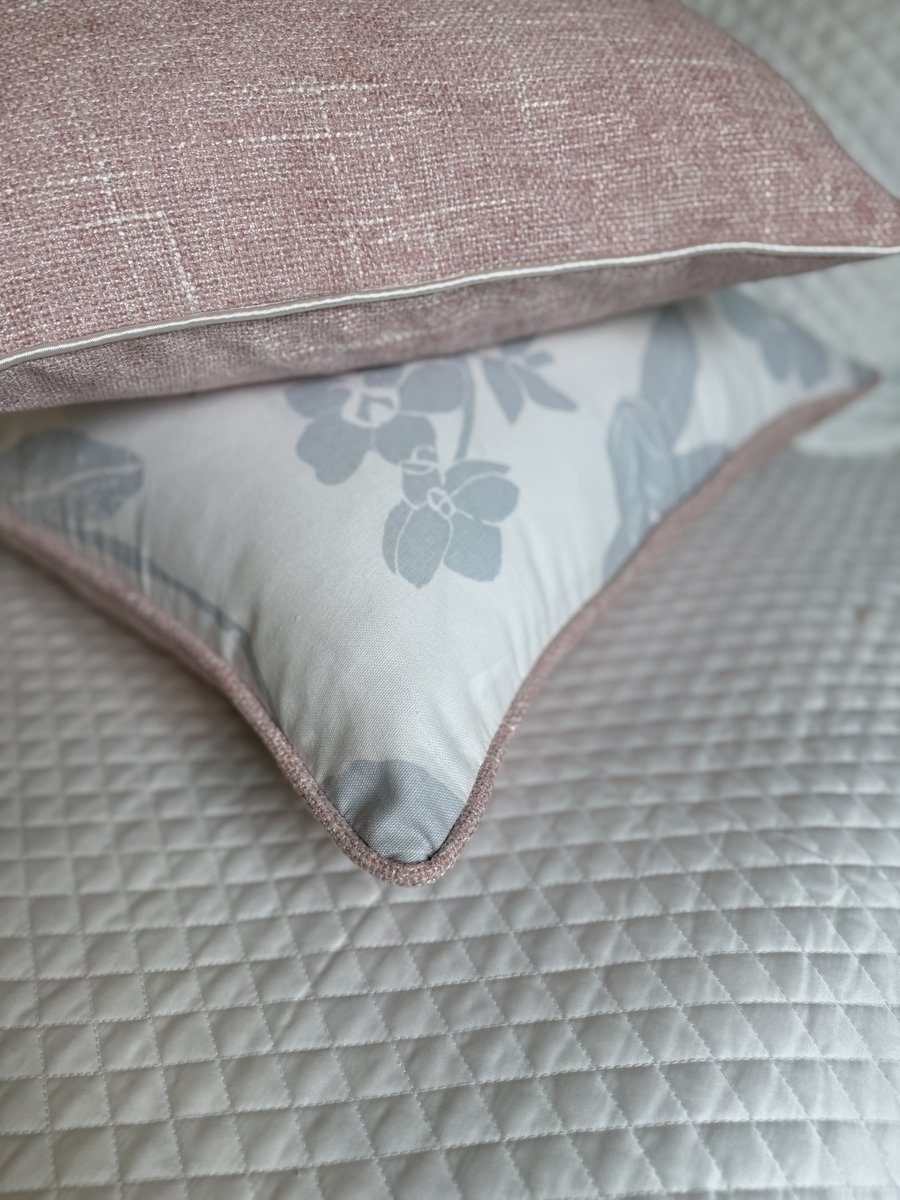 Orchids pillow blush piping corner detail stacked on quilted bedding