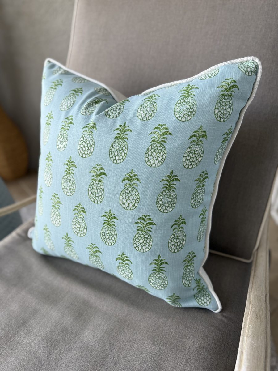 Pina Cove Schumacher pineapple pillow angled view on armchair