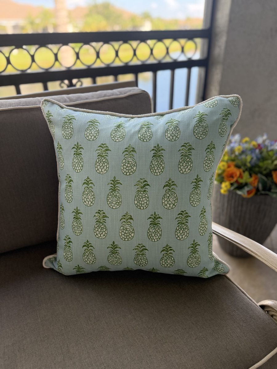 Pina Cove indoor outdoor pillow styled on patio sofa by PepperTree Designs