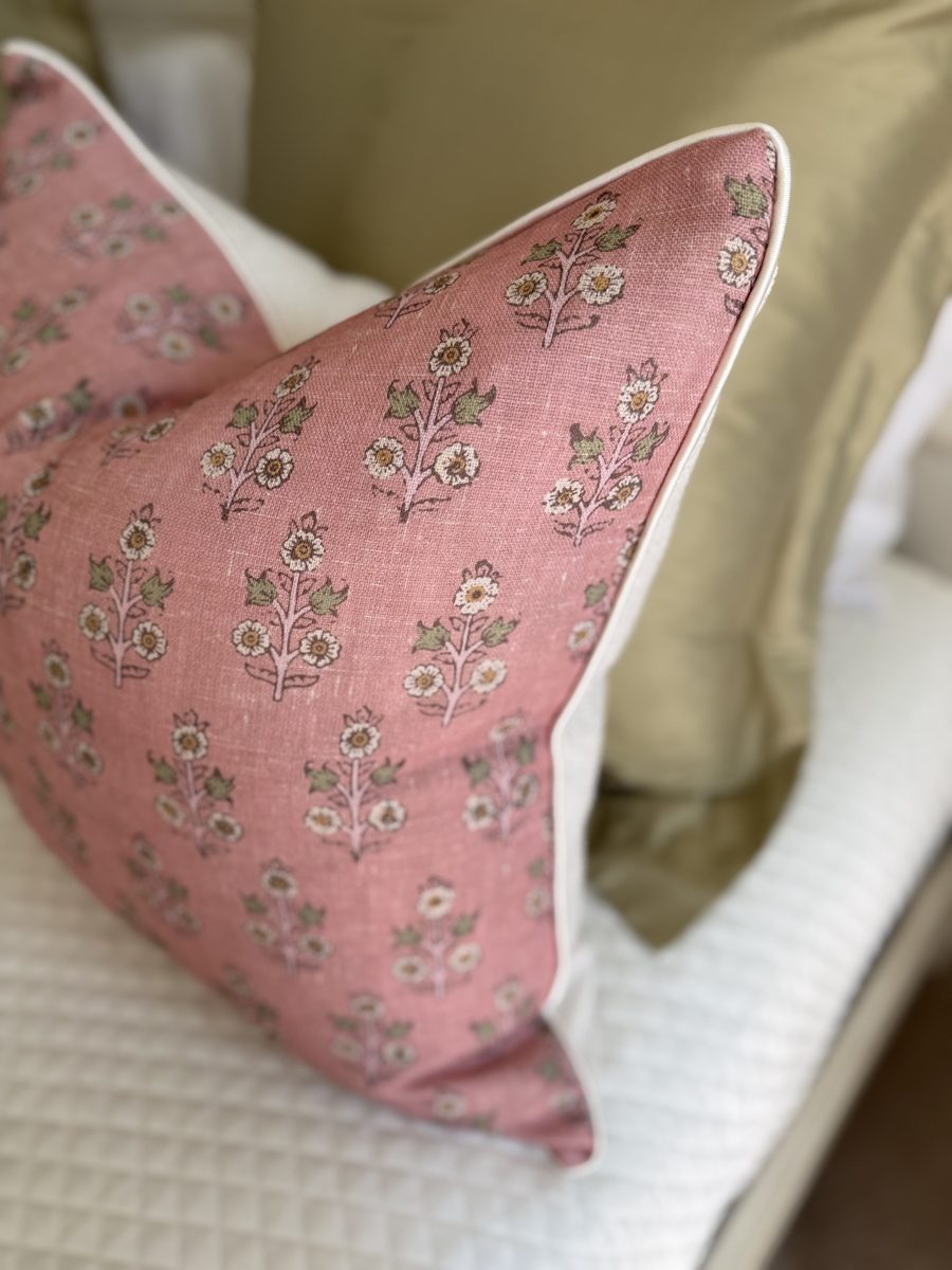 Poppy Sprig pillow corner detail with ivory piping on armchair