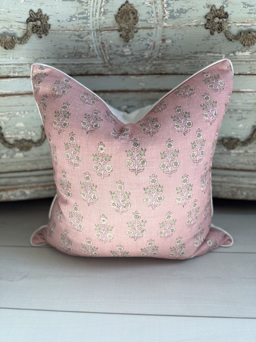 Poppy Sprig rose pillow with ivory piping in front of antique chest
