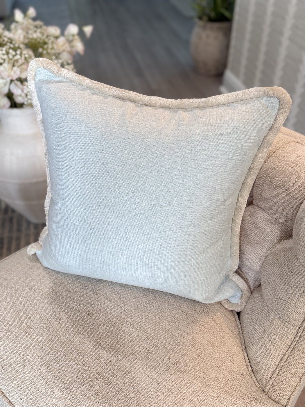 Simply Blue pale blue linen pillow with brush fringe on armchair by PepperTree Designs
