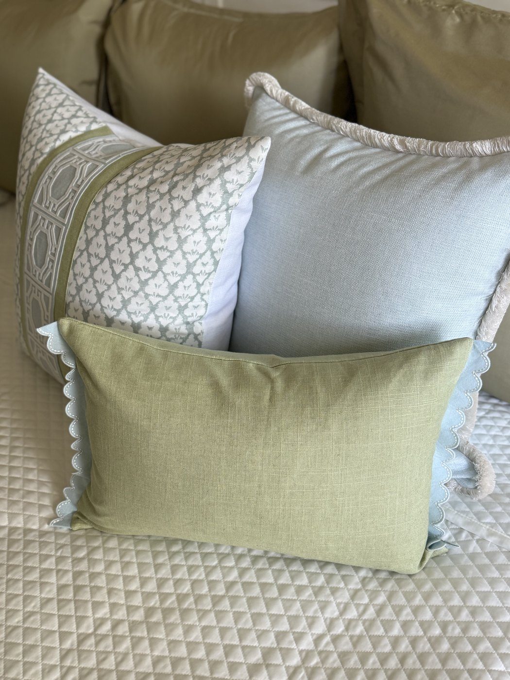 Simply Blue pillow grouped with sage block print and green lumbar pillows