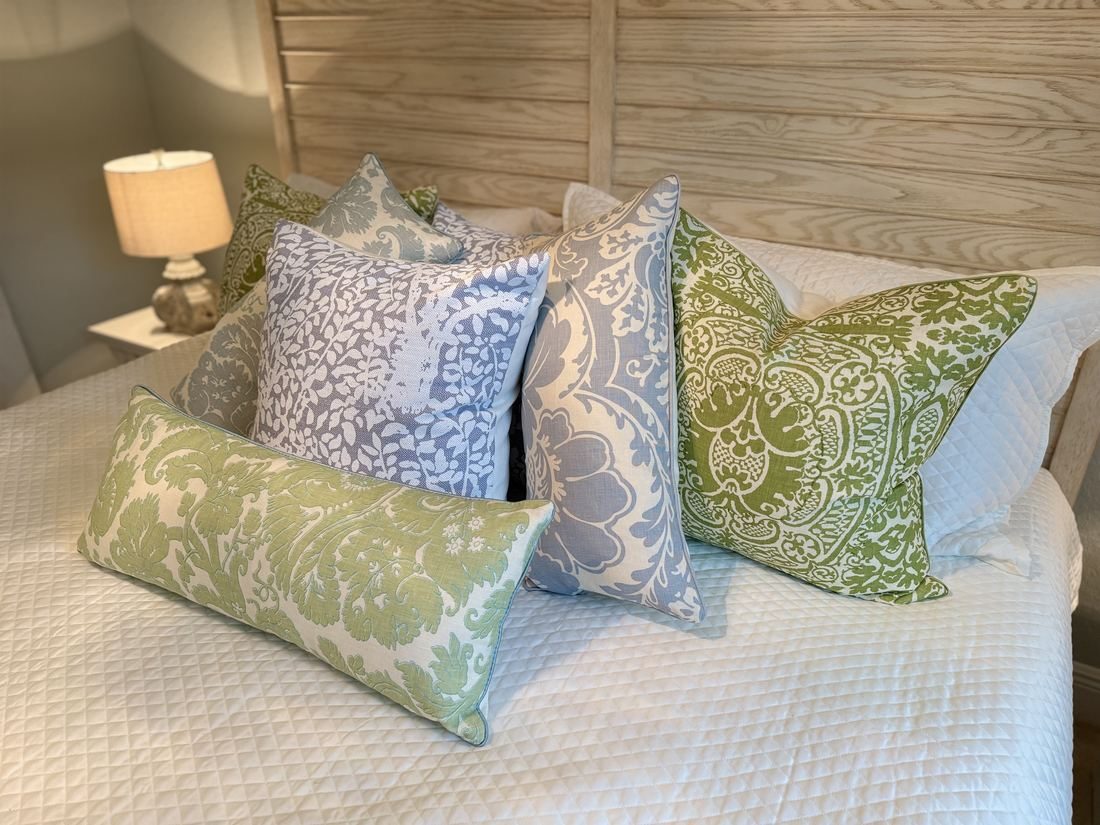 Veneto pillows styled on bed with PepperTree Designs collection